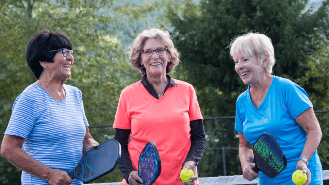 senior playing pickleball senior playing pickleball